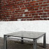 Vintage smoked glass coffee table with chrome structure.
