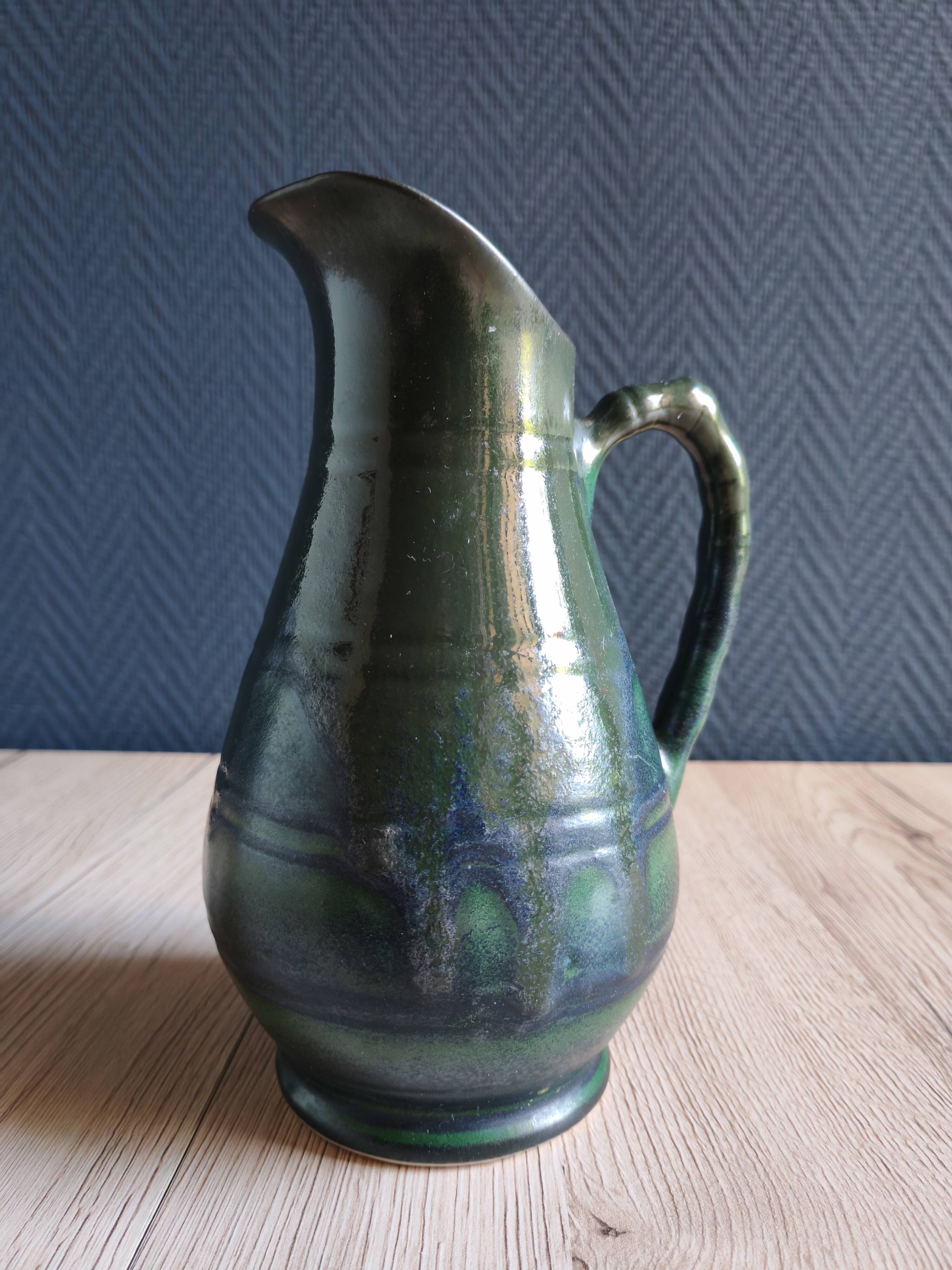 Vintage ceramic pitcher vase in glazed green and blue.