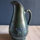 Vintage ceramic pitcher vase in glazed green and blue.
