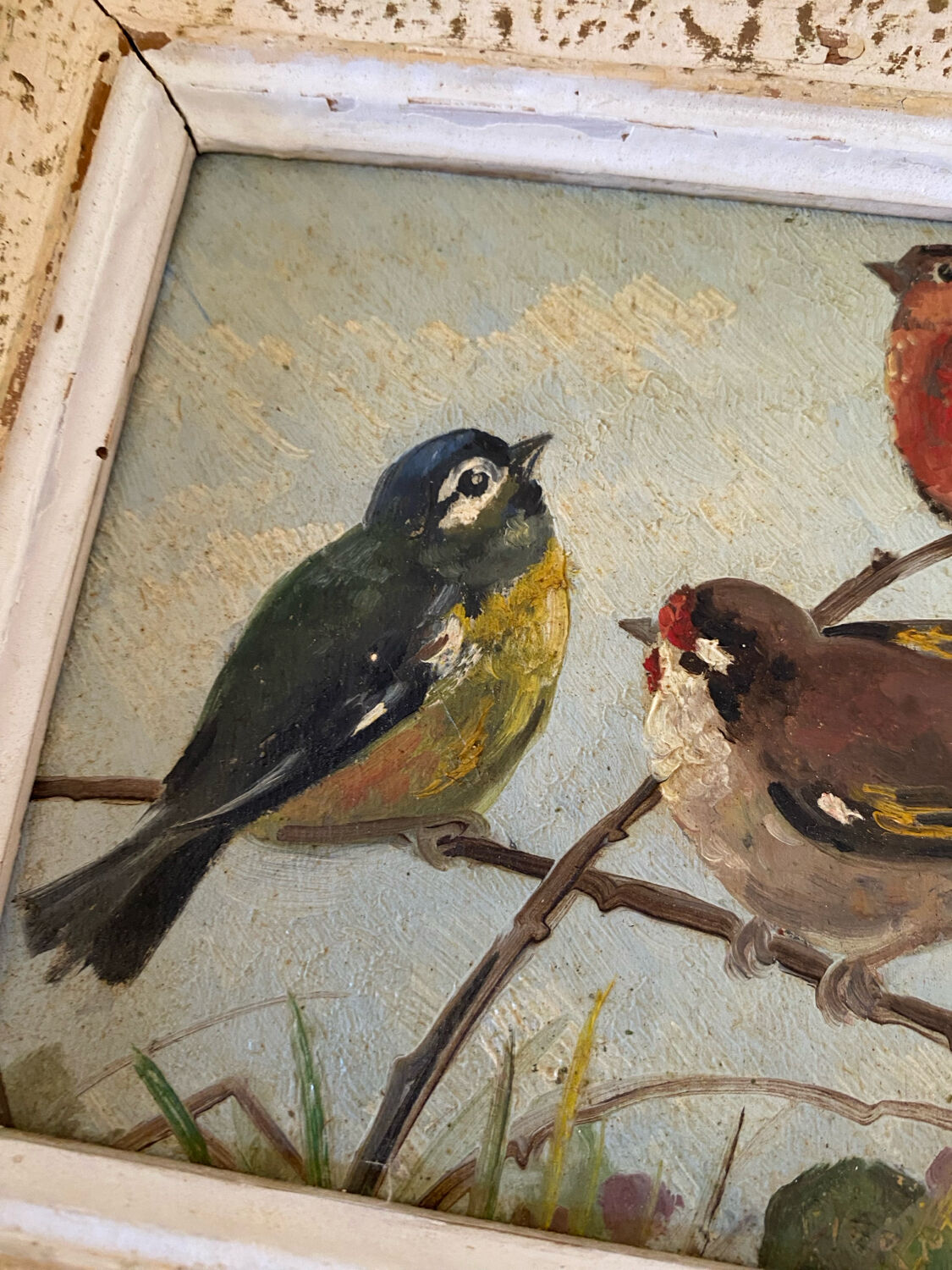 Vintage painting on panel of 3 tits on a branch.