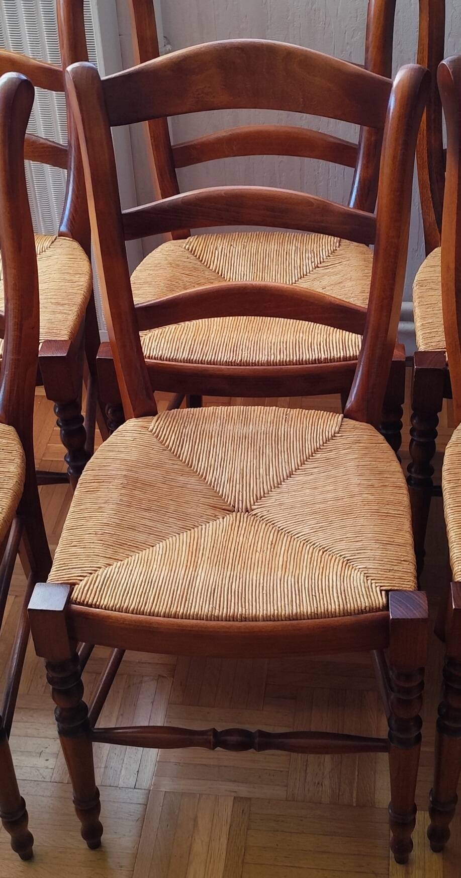 Set of 6 solid wood chairs with high-quality straw seats.