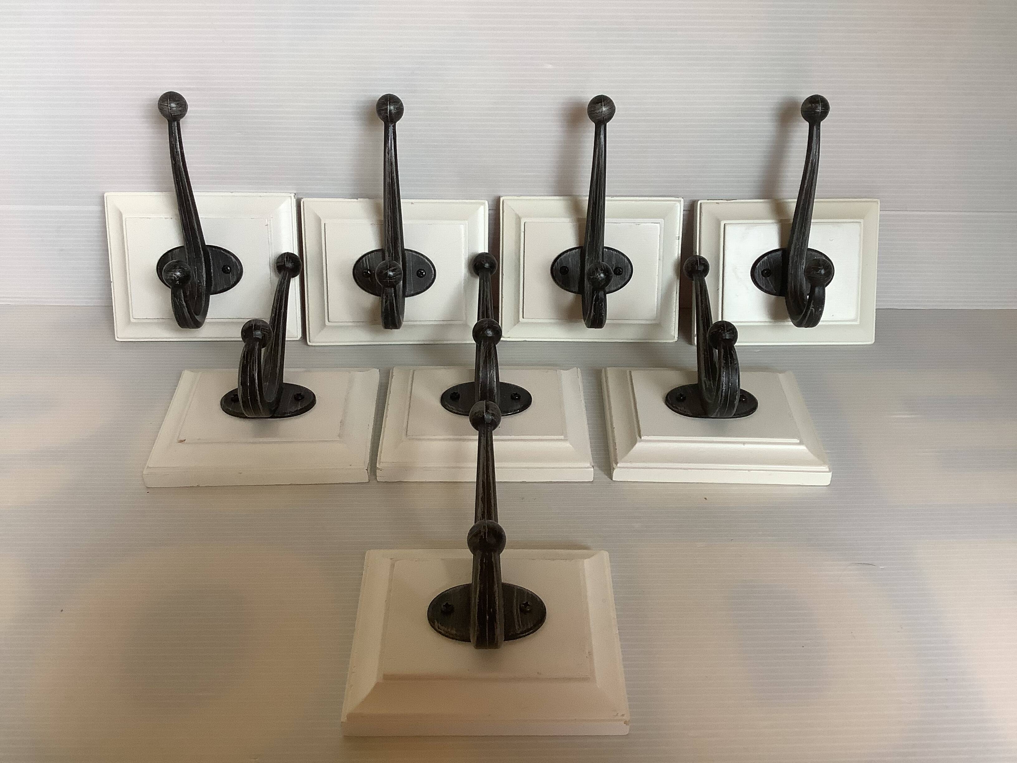 Eight double white wood metal hooks