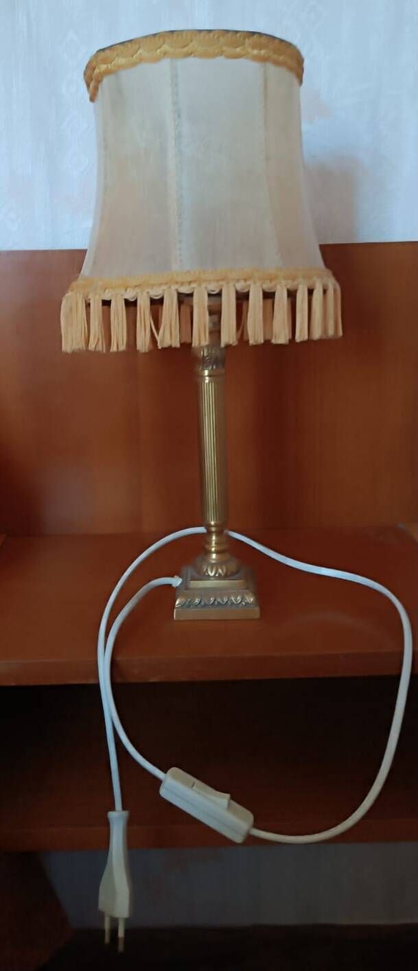 Brass bedside lamp with natural bladder shade.