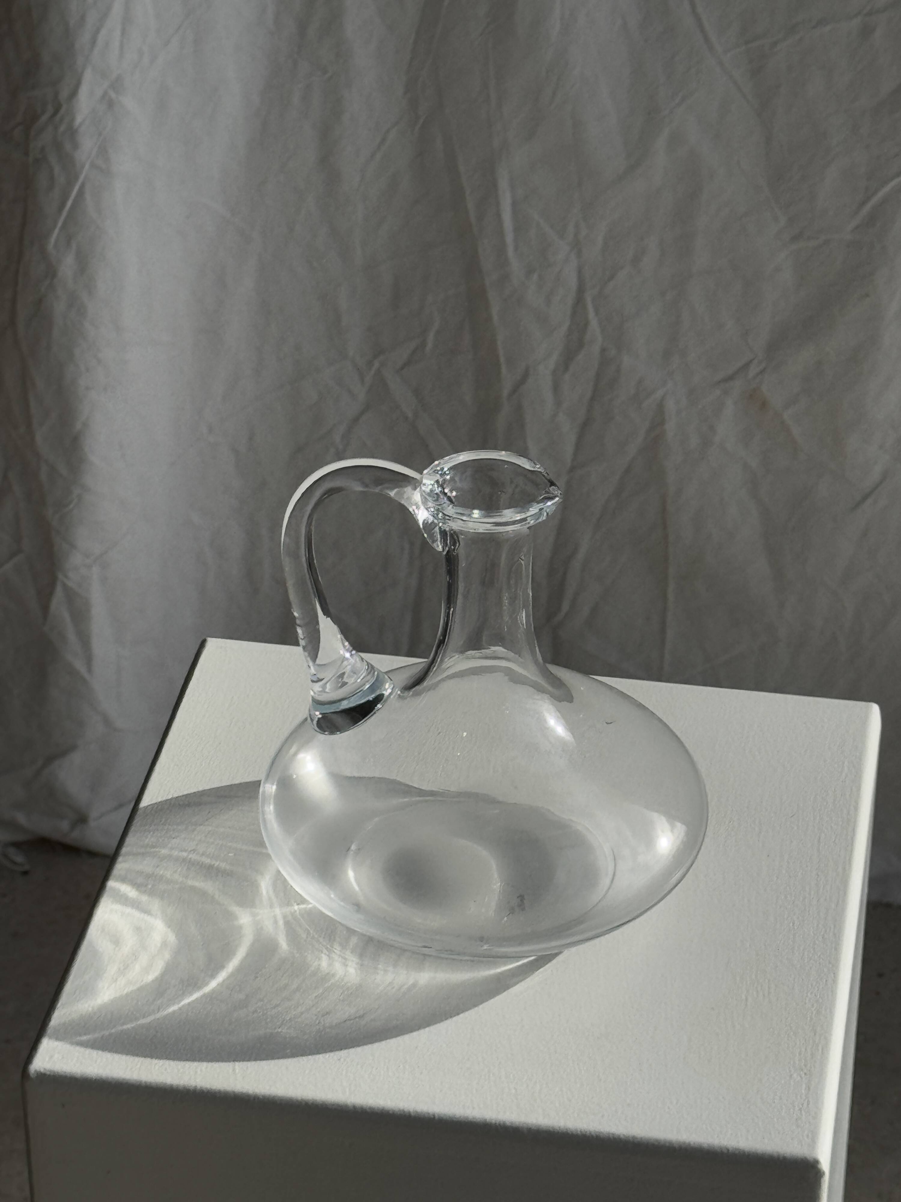 Vintage glass carafe with flattened flared belly handle H18