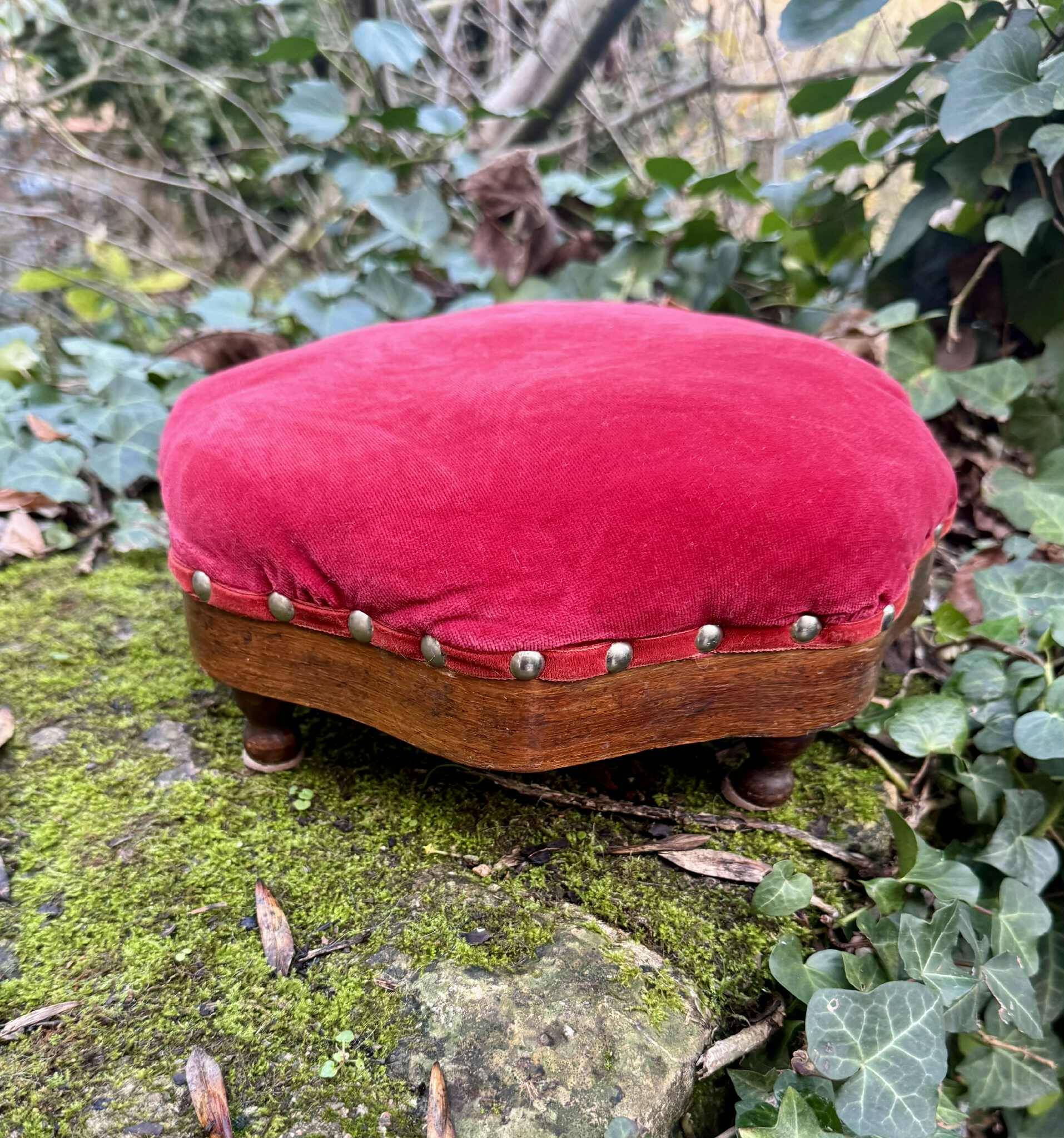 Red velvet footstool in the Louis XV style
