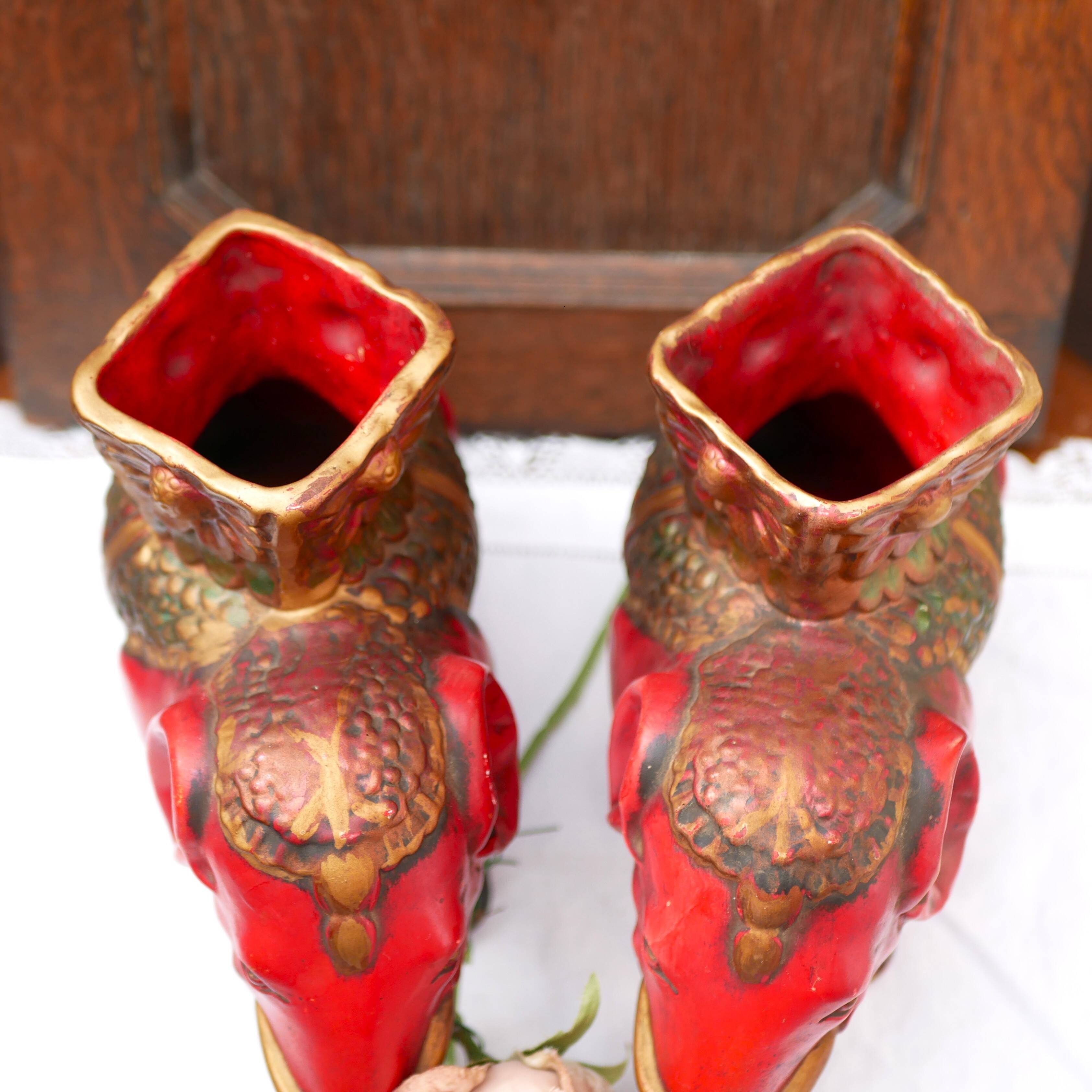 A pair of red and gold ceramic vases in the shape of elephants, 1940s.
