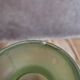 Small Art Deco round vase in moulded green pressed glass – relief decoration