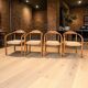 Set of 4 solid wood chairs with cord and armrests.