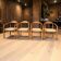 Set of 4 solid wood chairs with cord and armrests.