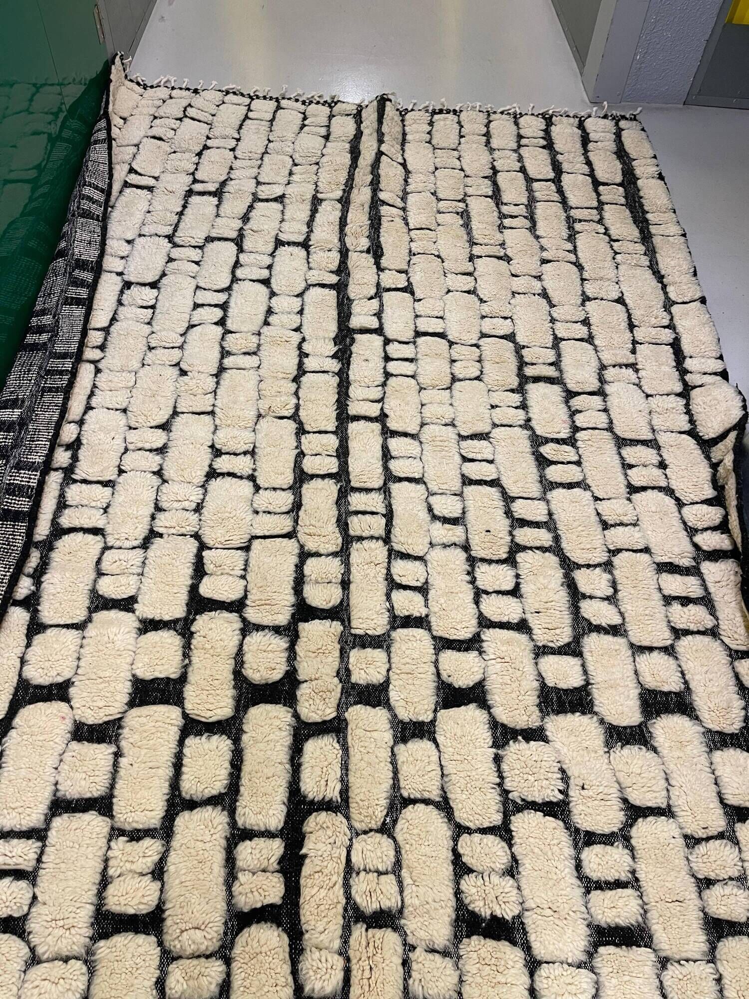 Large cream and black checked Berber rug, 280 × 200 cm.