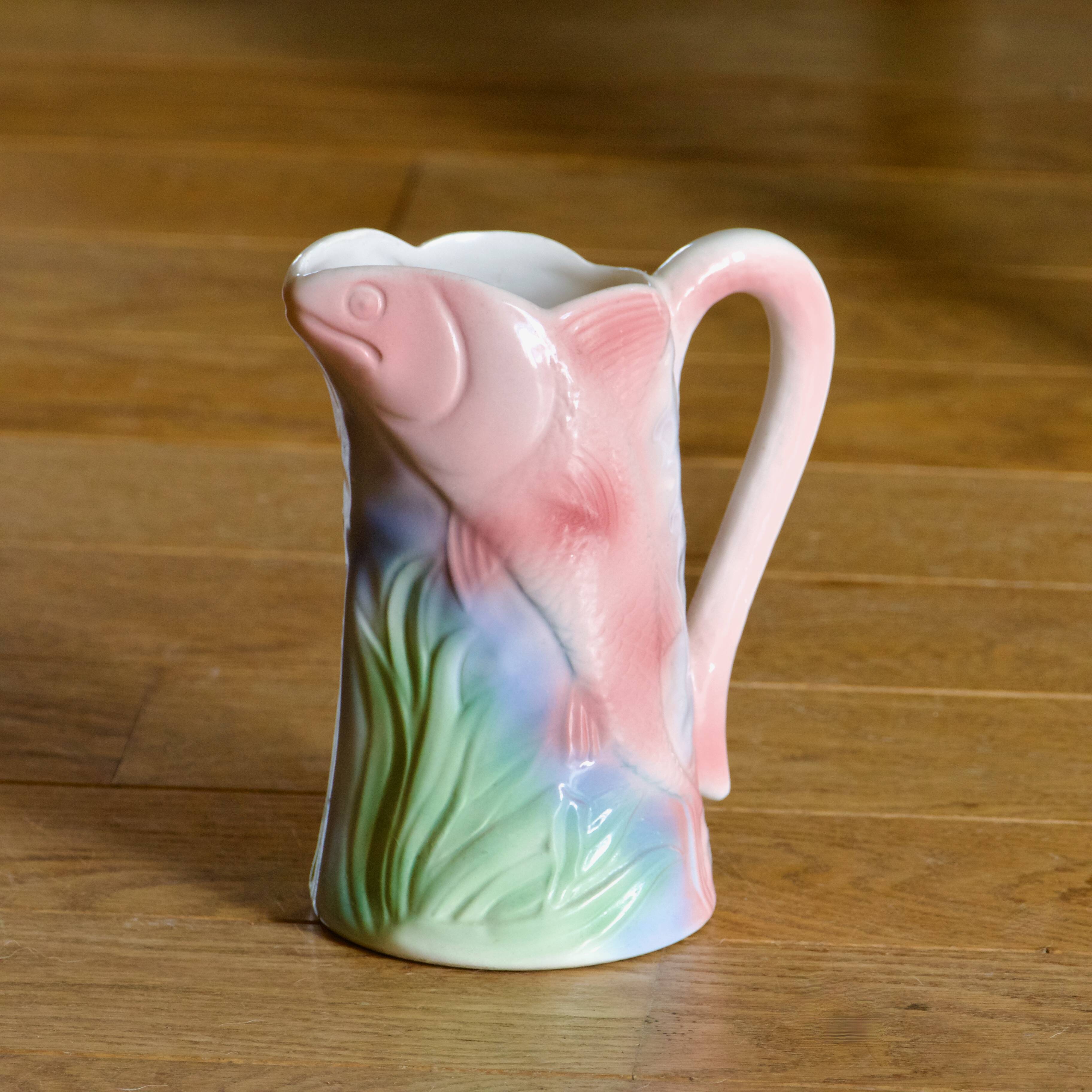 Vintage carafe in colorful fish slip