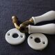 Set of two porcelain door handles with two rosettes