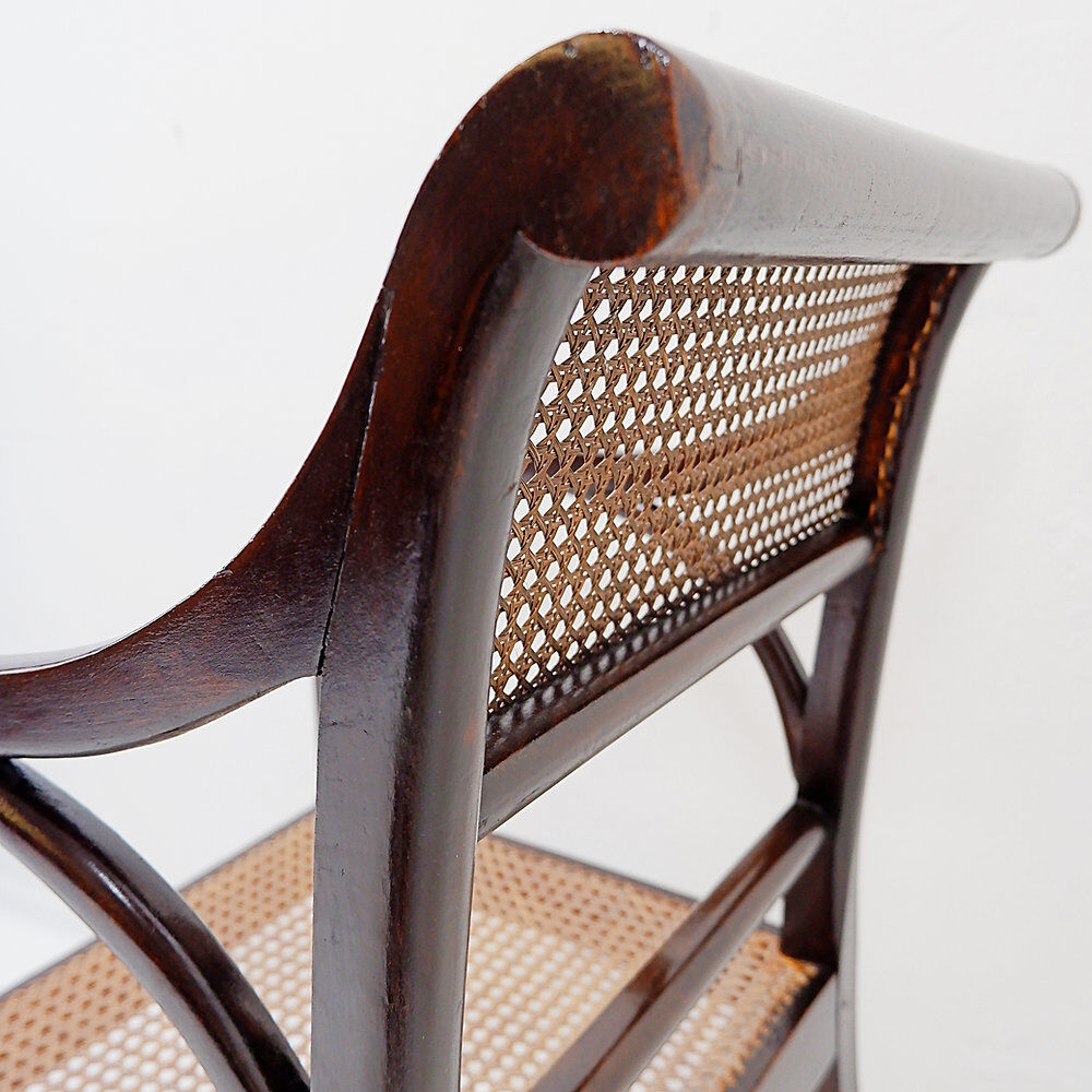 Mid-century curved wooden chairs with cane seats and backs.