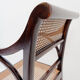 Mid-century curved wooden chairs with cane seats and backs.