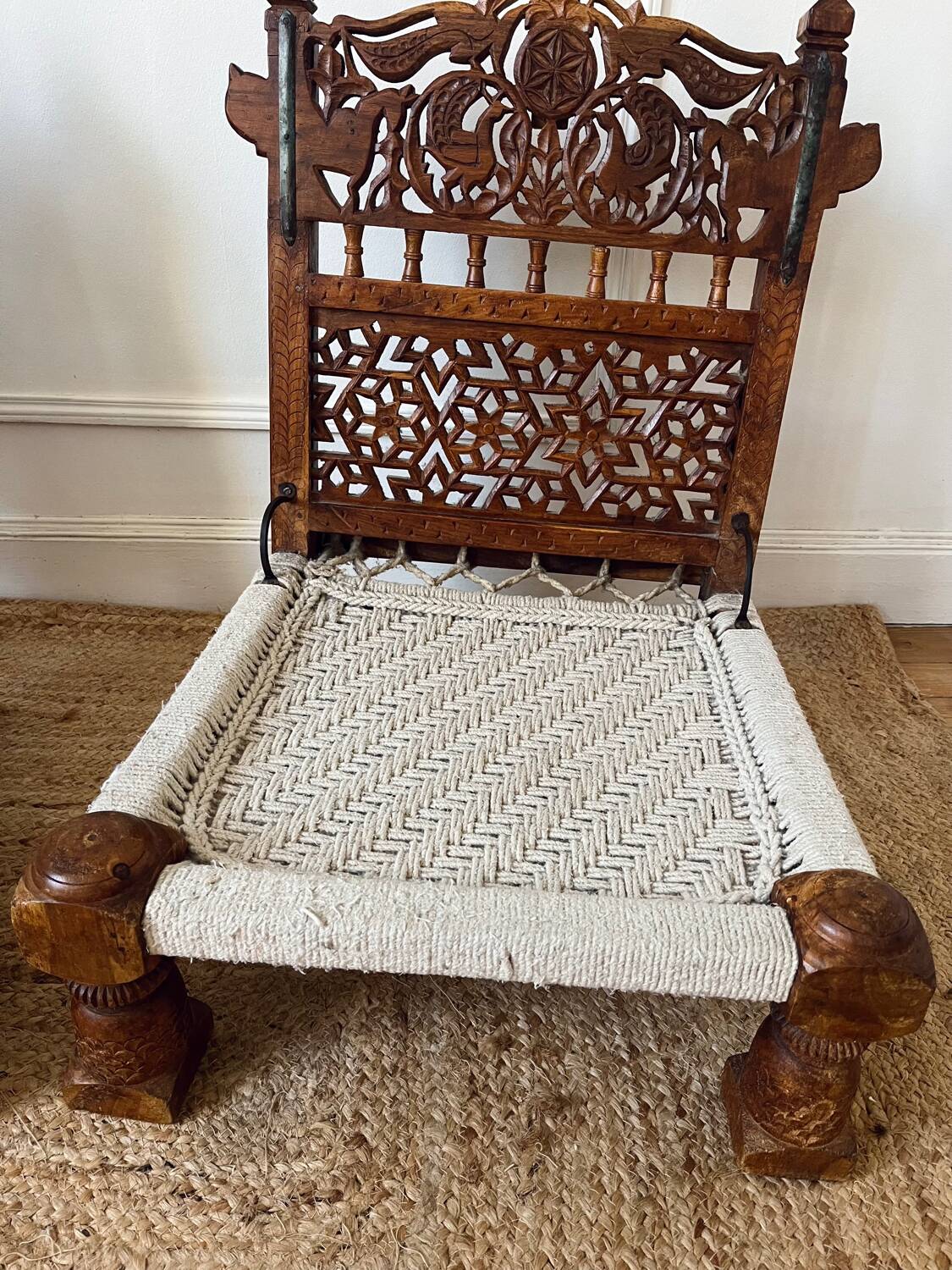Pair of traditional Indian chairs made of carved wood and rope
