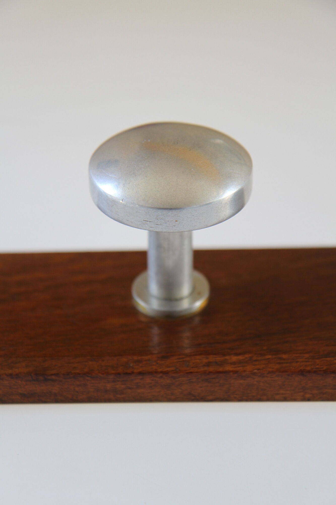 Wooden and stainless steel coat holders from the 1920s
