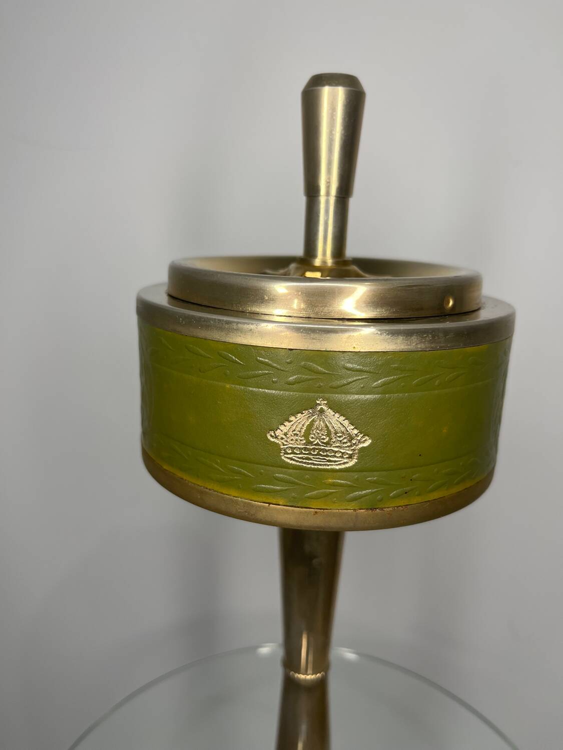 Vintage brass floor ashtray with glass shelf in Empire style.