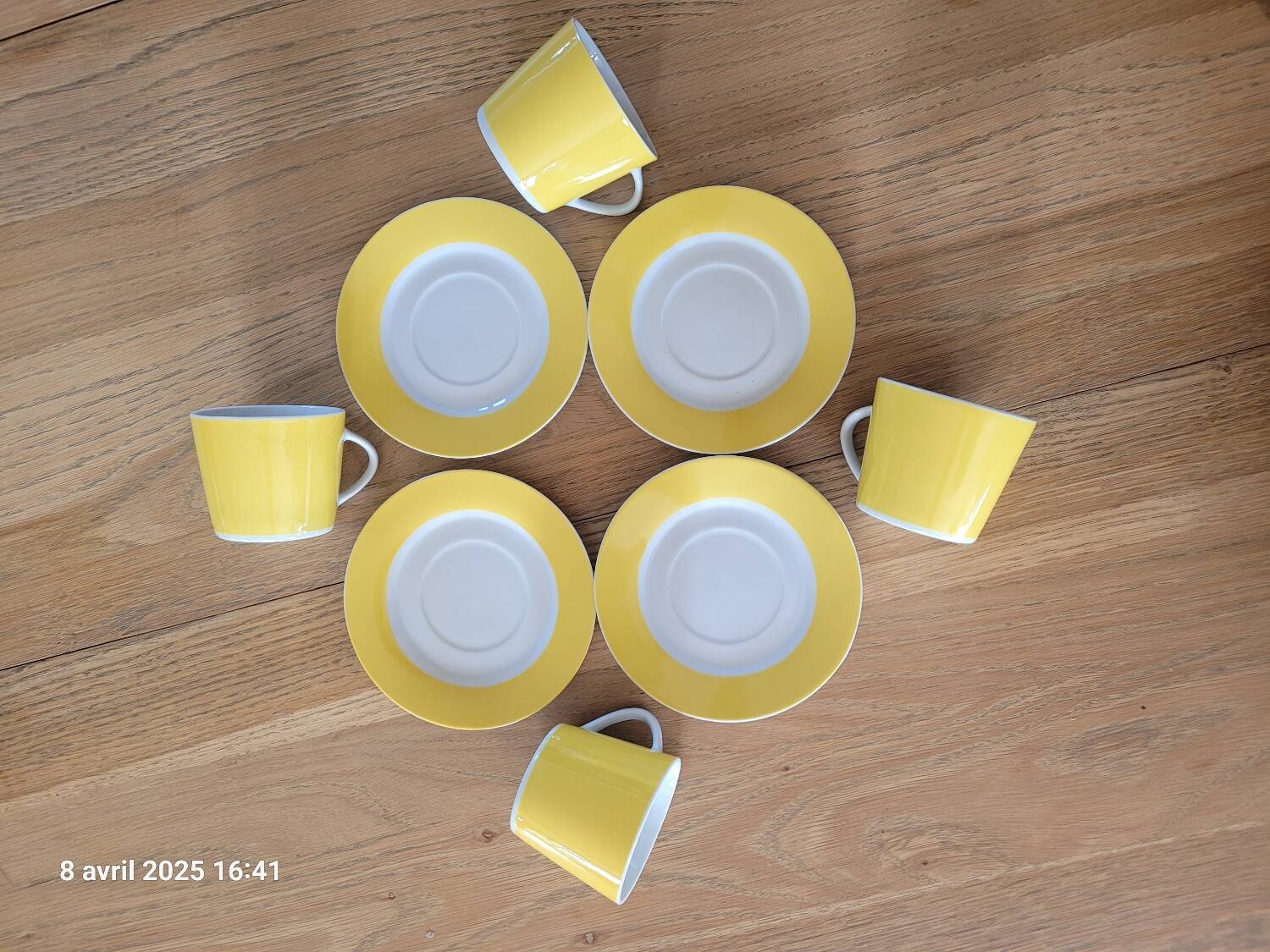 4 yellow and white cups and saucers