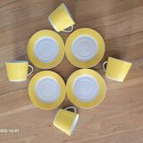 4 yellow and white cups and saucers
