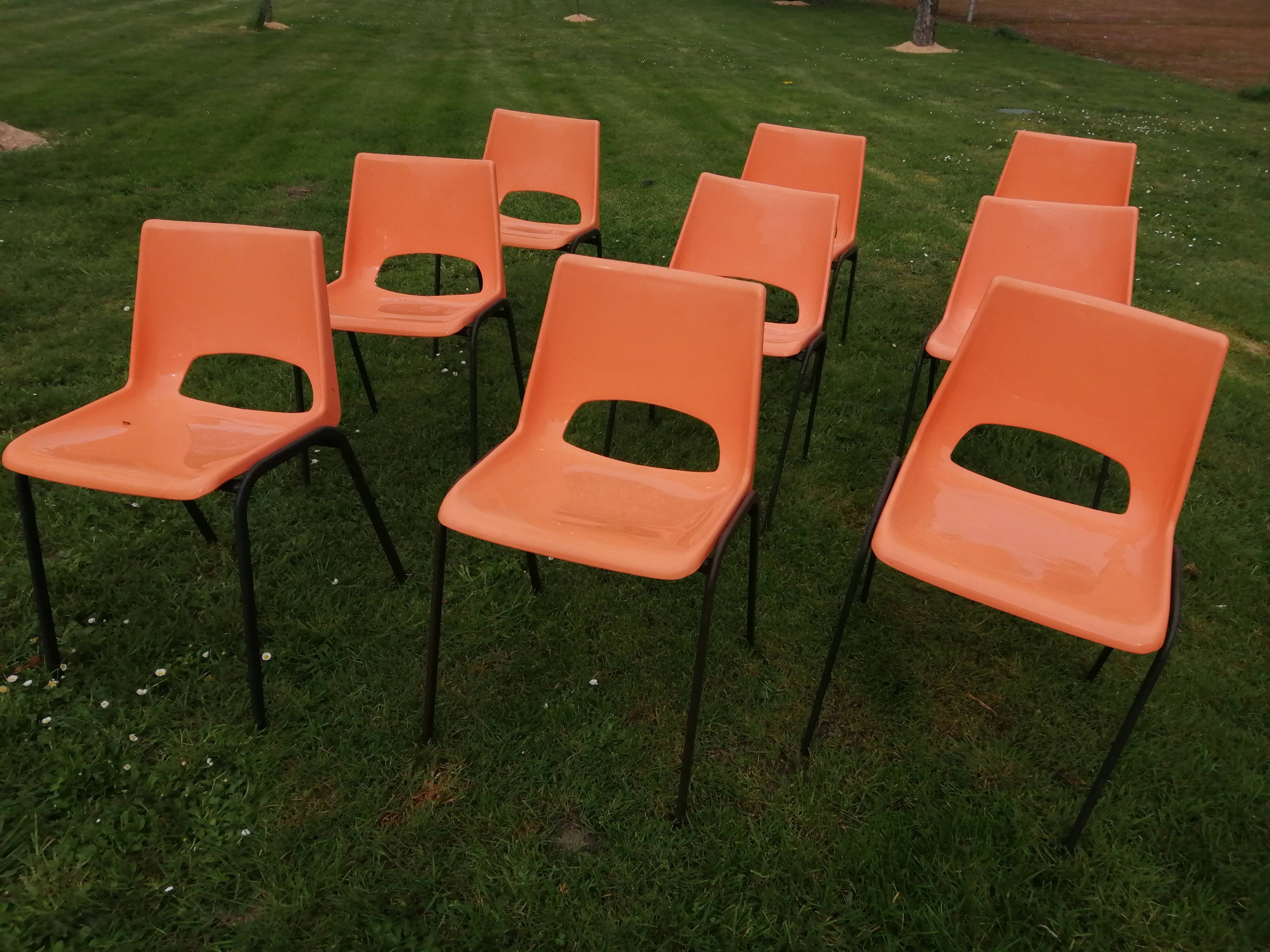 9 vintage orange plastic adult chairs