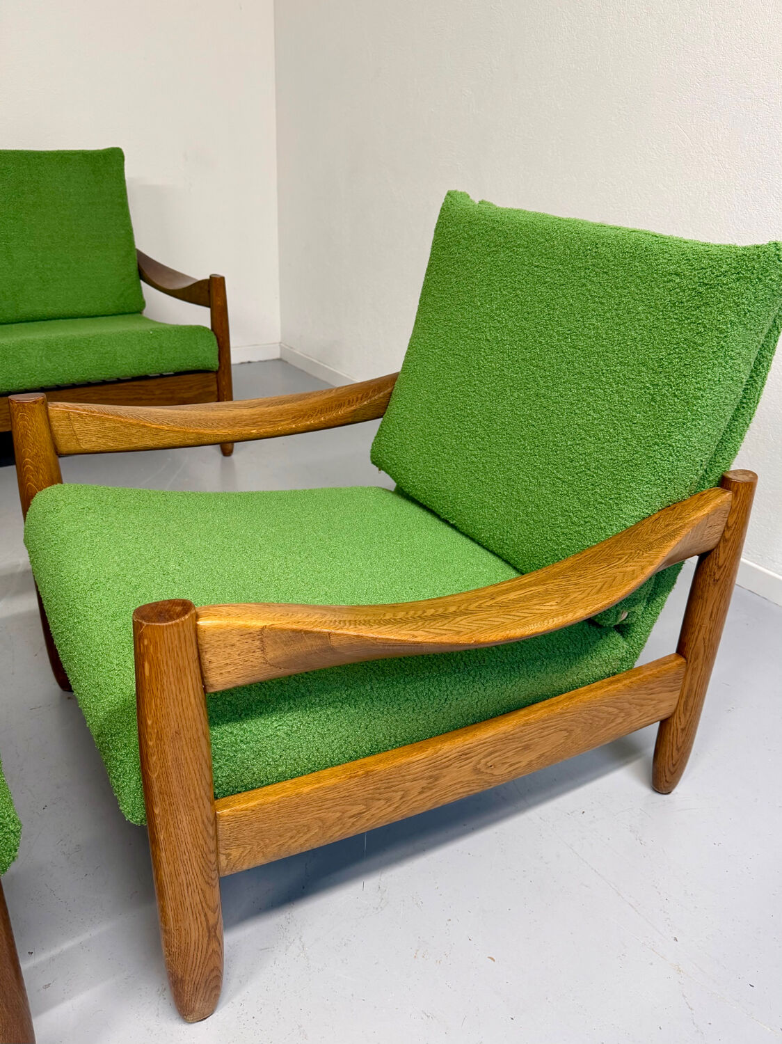 Living room sofa and Scandinavian design armchairs from the 1960s in green boucle.