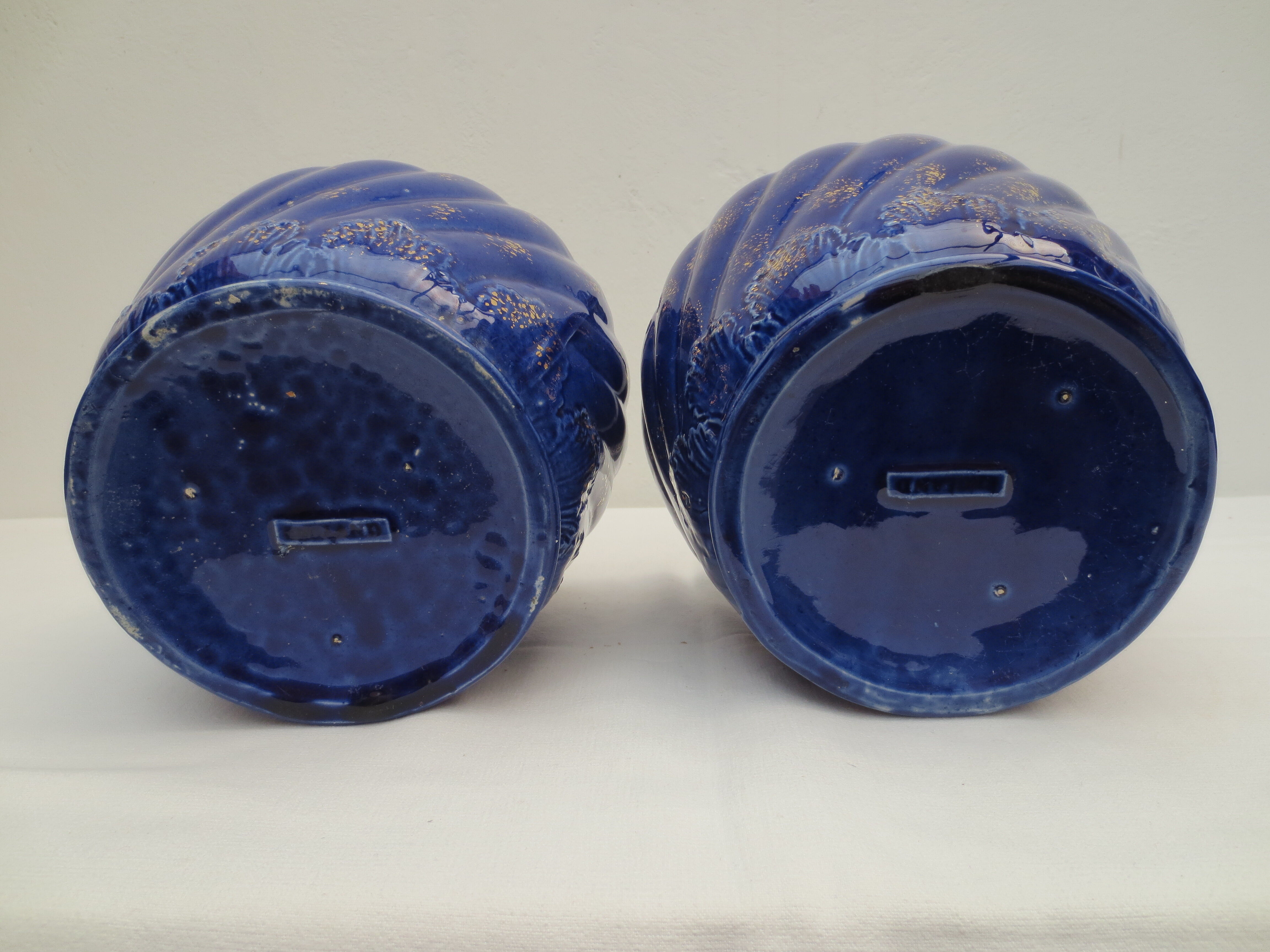 Pair of cache-old pots in midnight blue and gold ceramic