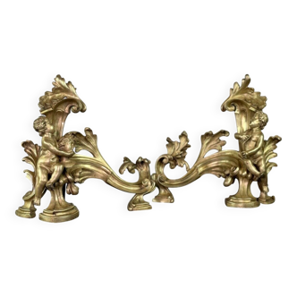 Pair of chiselled and gilded bronze andirons after a model by Jacques Caffieri, Paris 19th century.