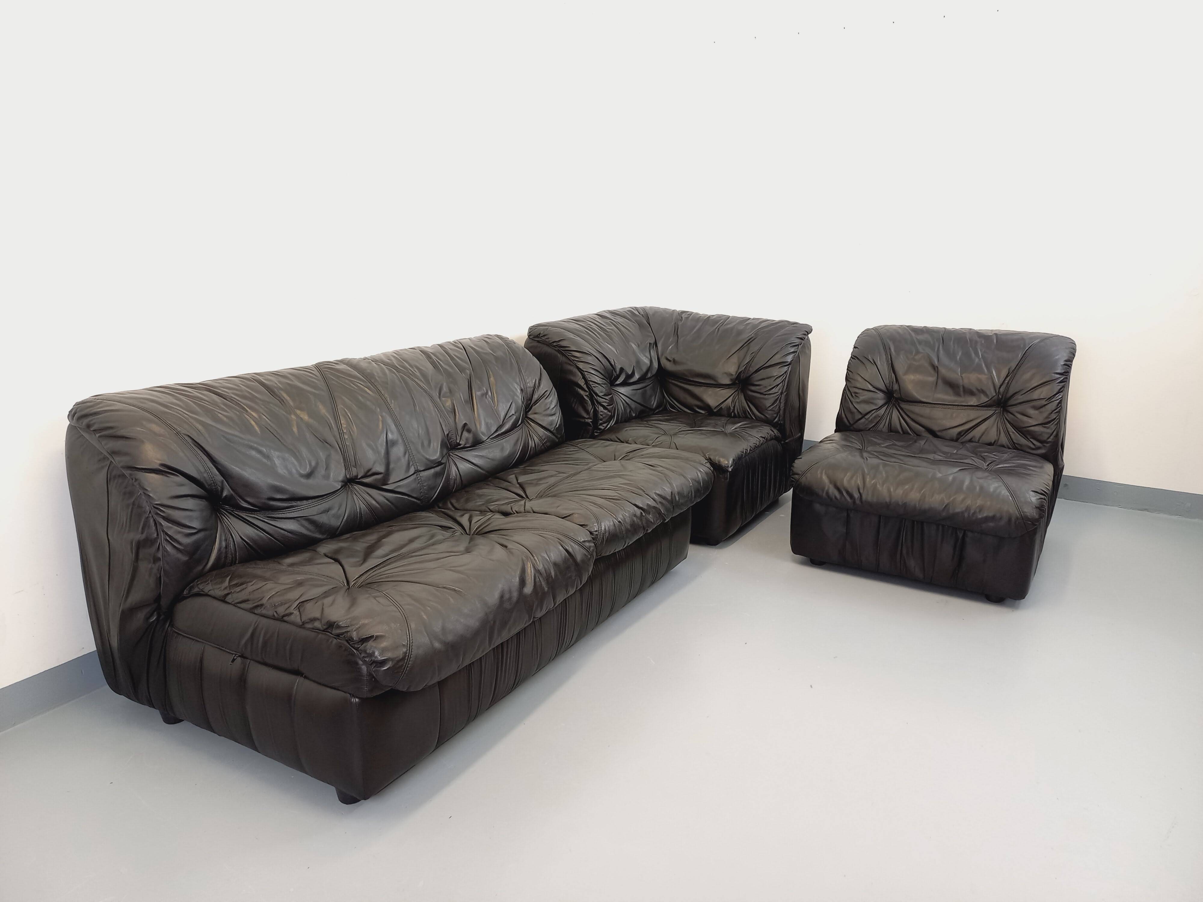Vintage corner sofa composed of 3 modules in black leather with integrated bed.