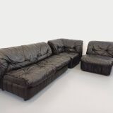 Vintage corner sofa composed of 3 modules in black leather with integrated bed.