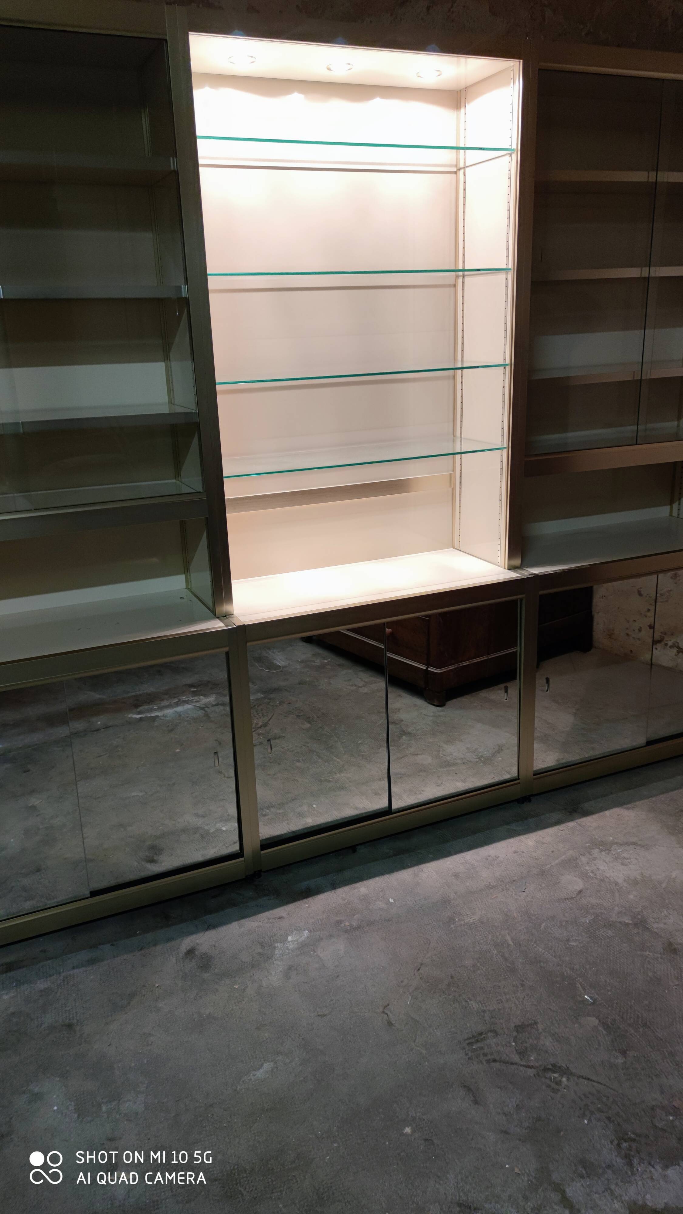 Ivory-colored and matte gold anodized aluminum display bookcase