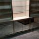Ivory-colored and matte gold anodized aluminum display bookcase
