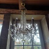 Antique chandelier with pendants in bronze and crystal.