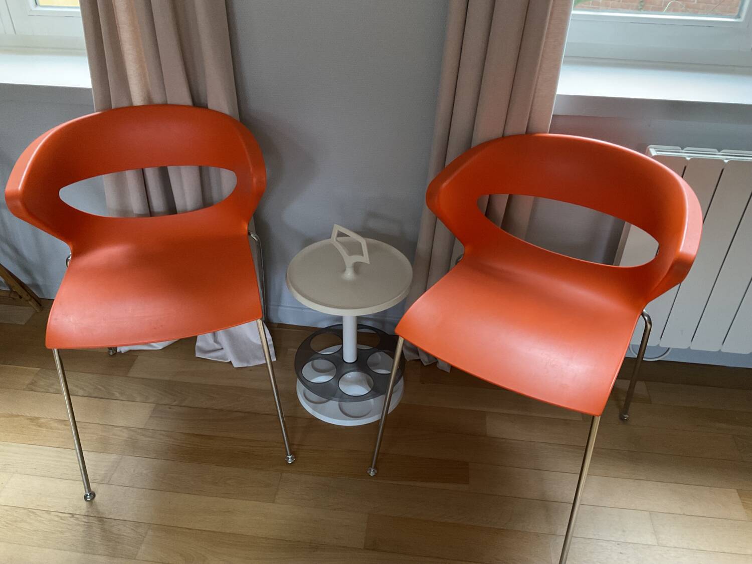 Two orange kicca chairs made in italy tbe