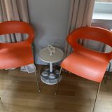 Two orange kicca chairs made in italy tbe
