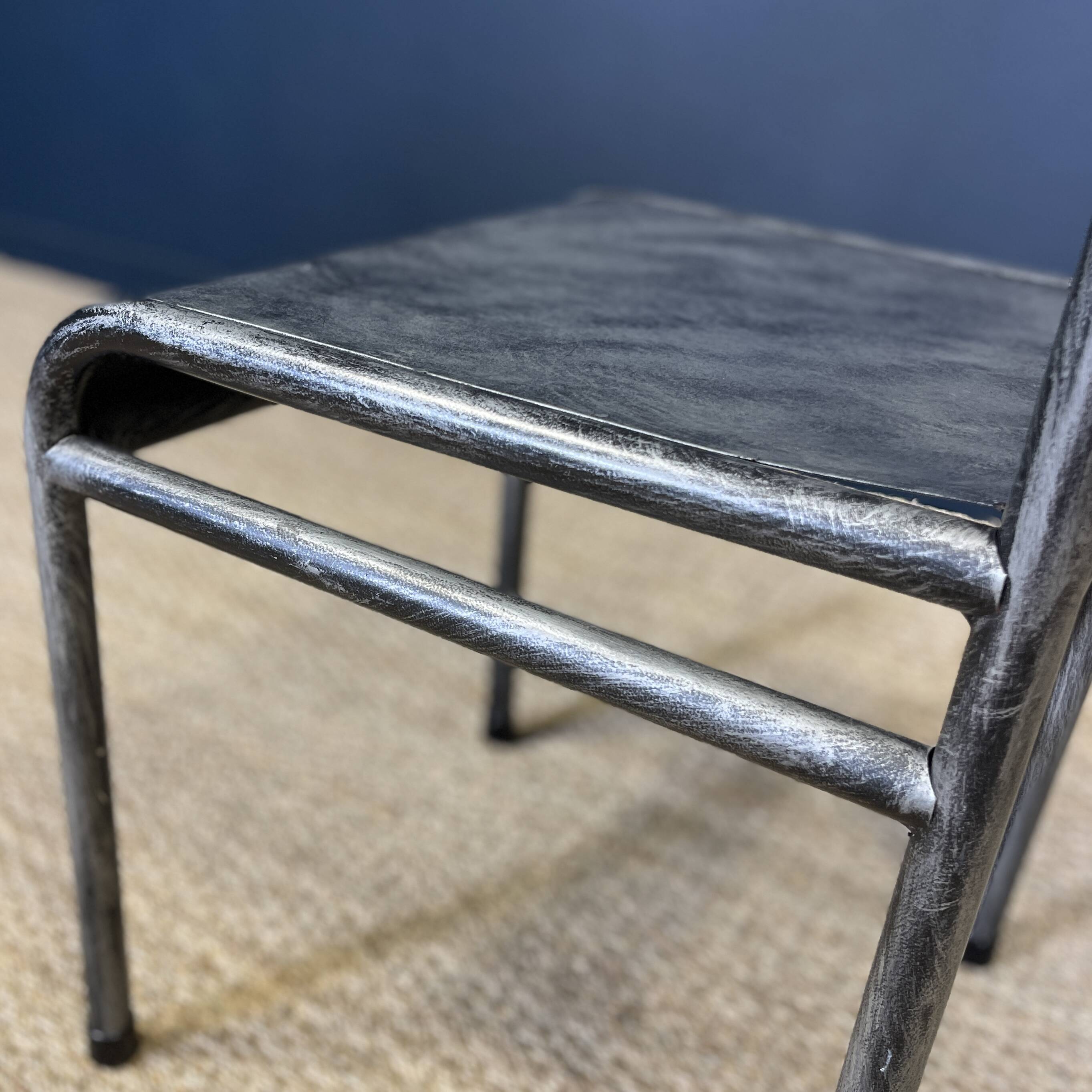 Pair of gray metal industrial chairs