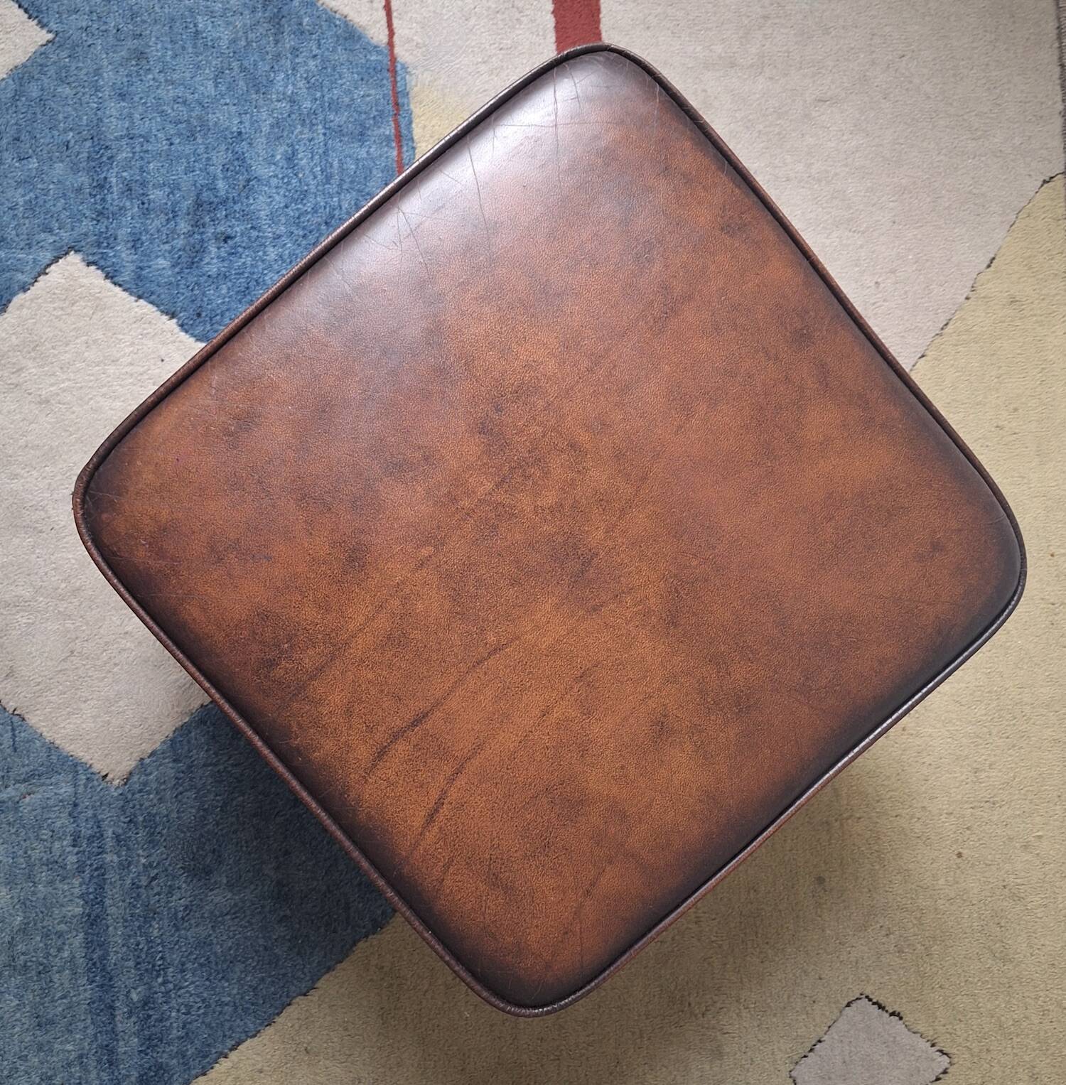 Vintage ottoman / pouffe in chestnut brown leather