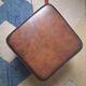 Vintage ottoman / pouffe in chestnut brown leather
