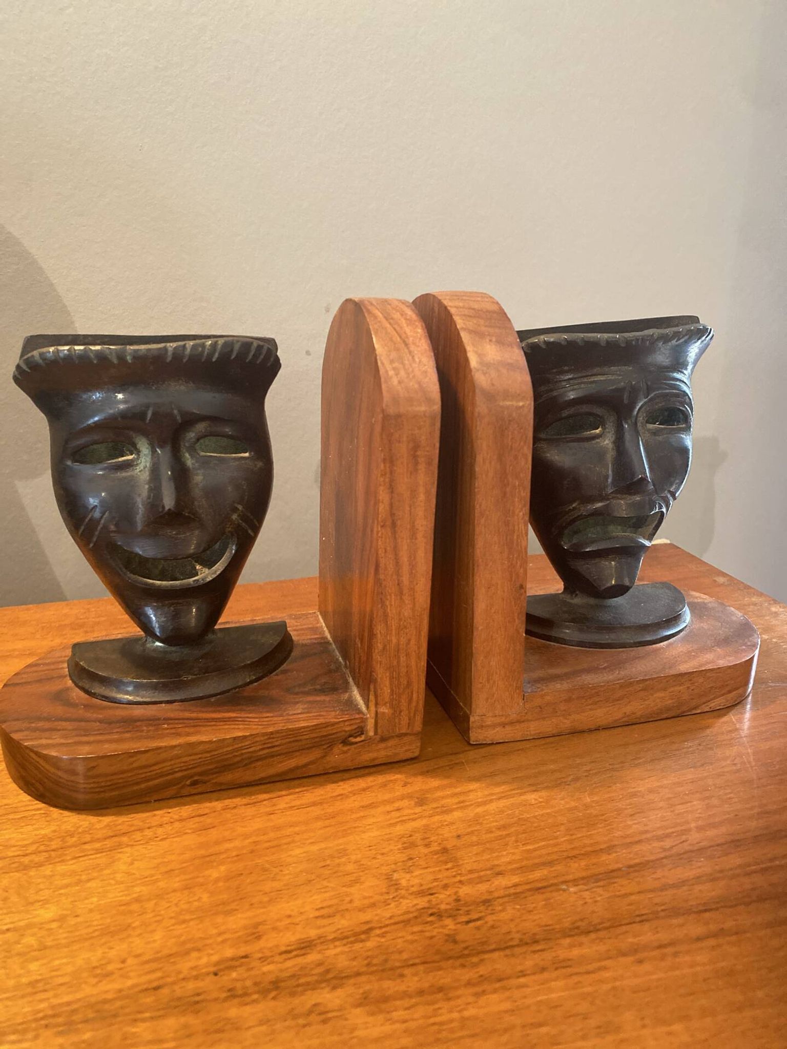 Pair of bronze bookends with masks