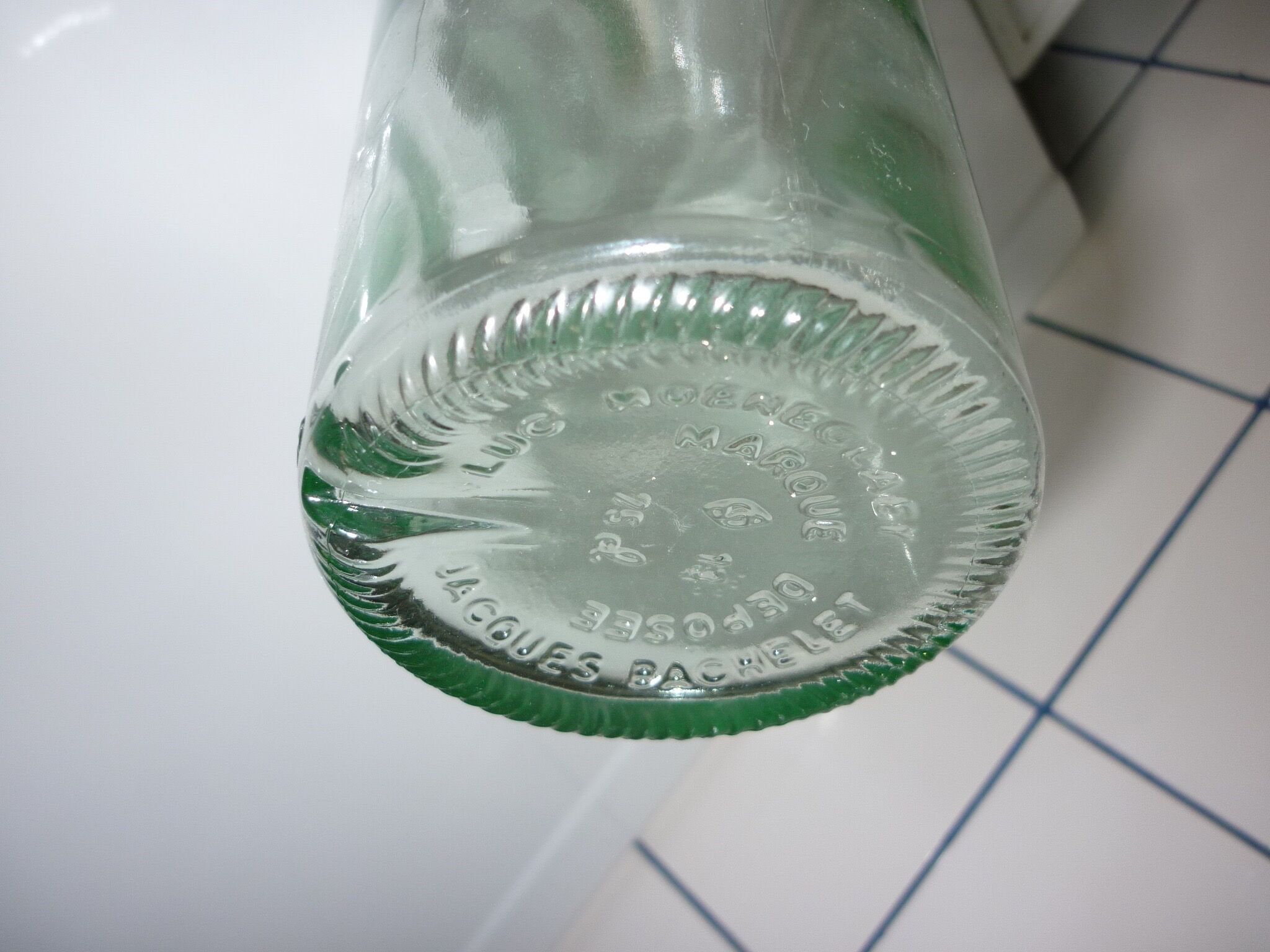 Old transparent moulded glass bottle