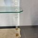 Hollywood Regency console style in travertine, glass, and Lucite.