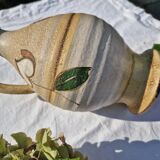 Handcrafted jug or jar with a handle, terracotta pottery vase, fat lava effect, stylized flowers