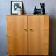 Vintage 1960s shoe cabinet in light wood and chrome metal.