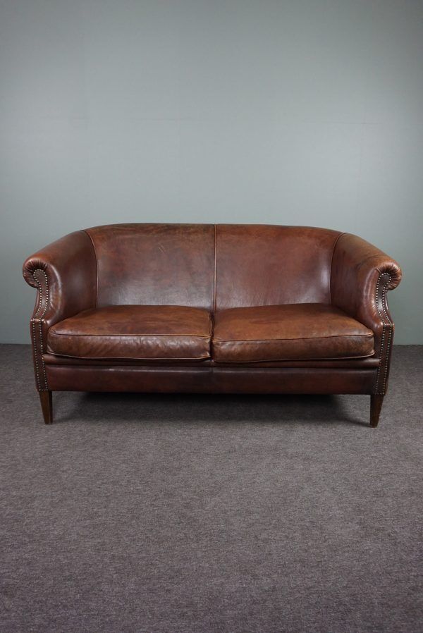 2-seater sofa in sheepskin decorative nails