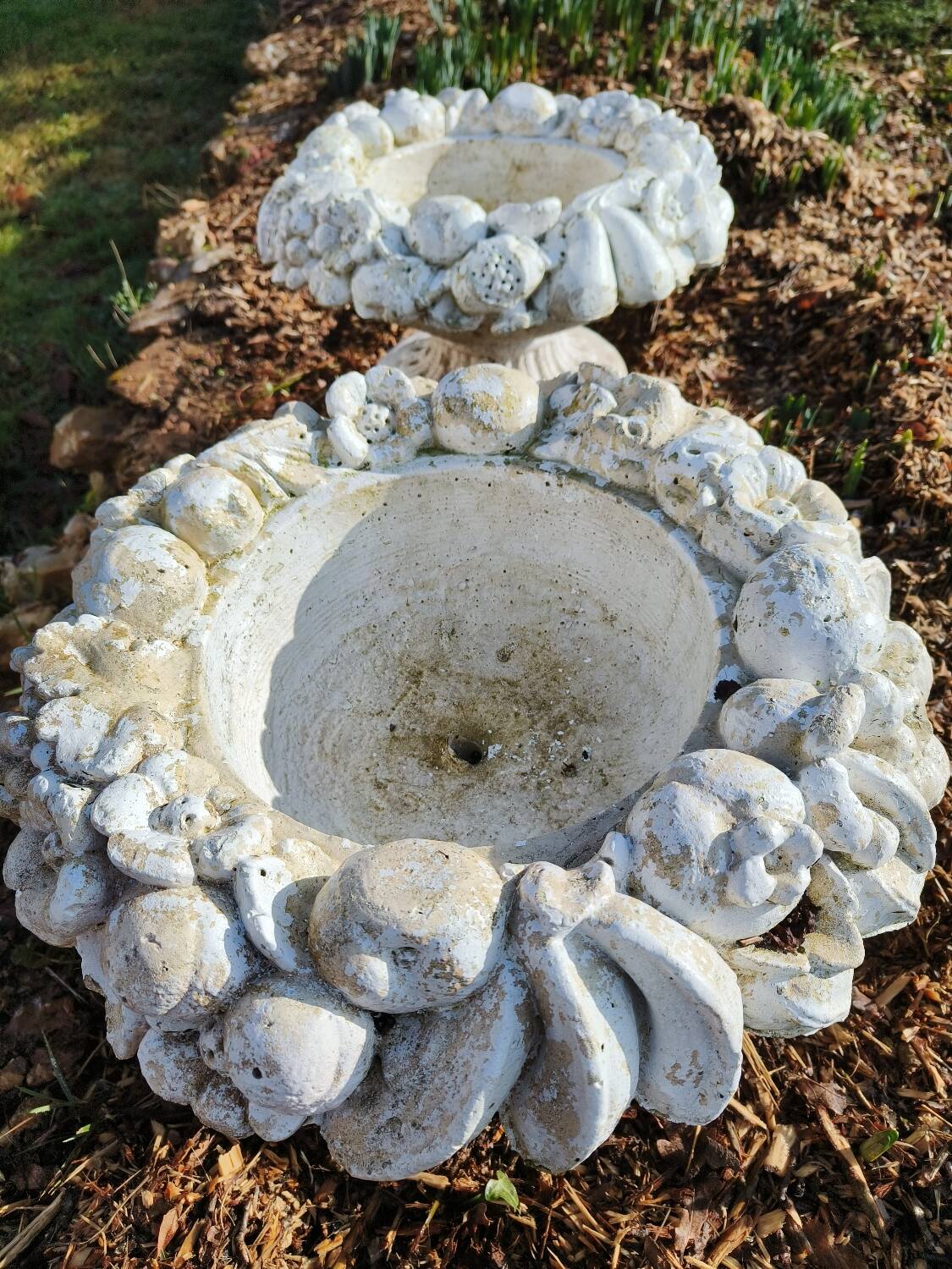 Pair of round stone fruit bowls on foot