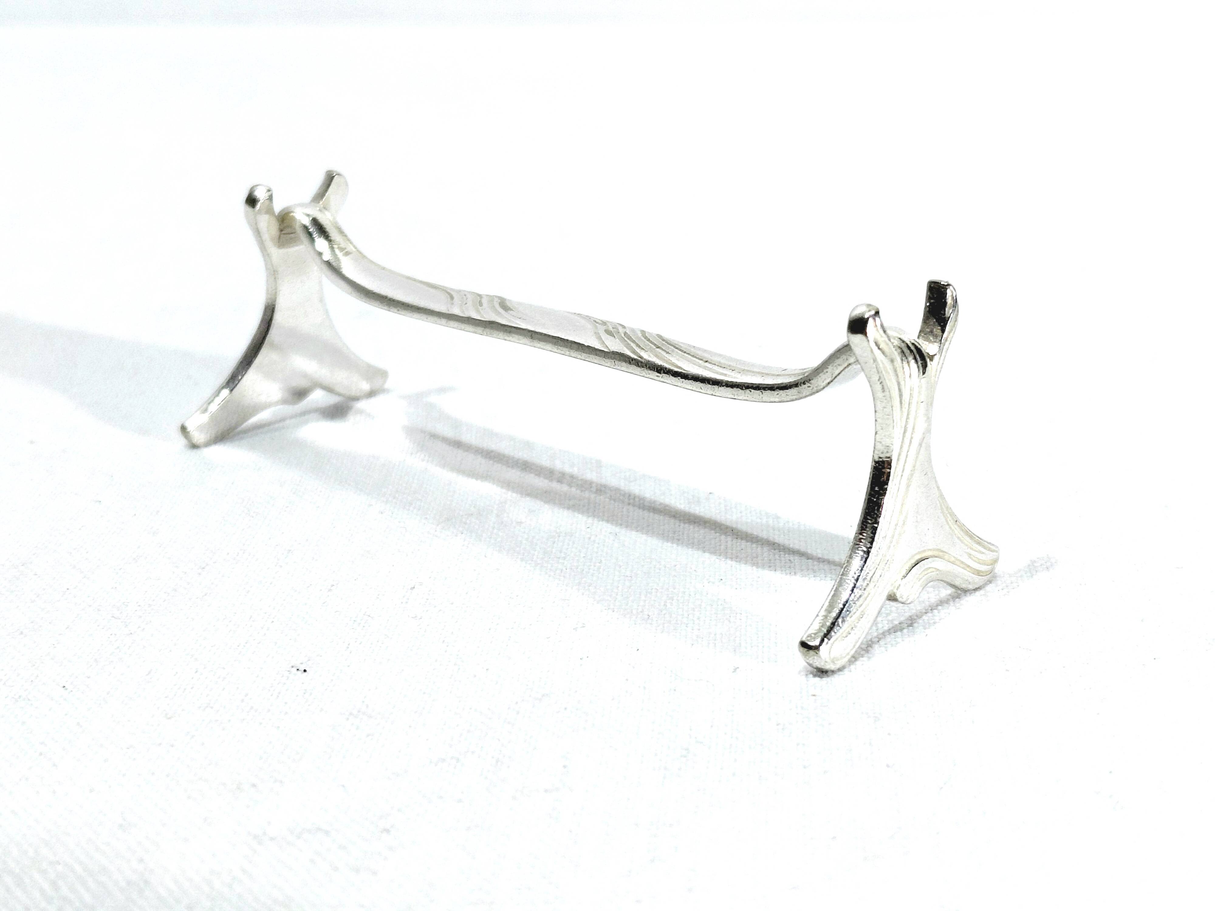 CHRISTOFLE - SET OF 11 SILVER-PLATED KNIFE RESTS