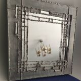 Tin mirror on brutalist wood support