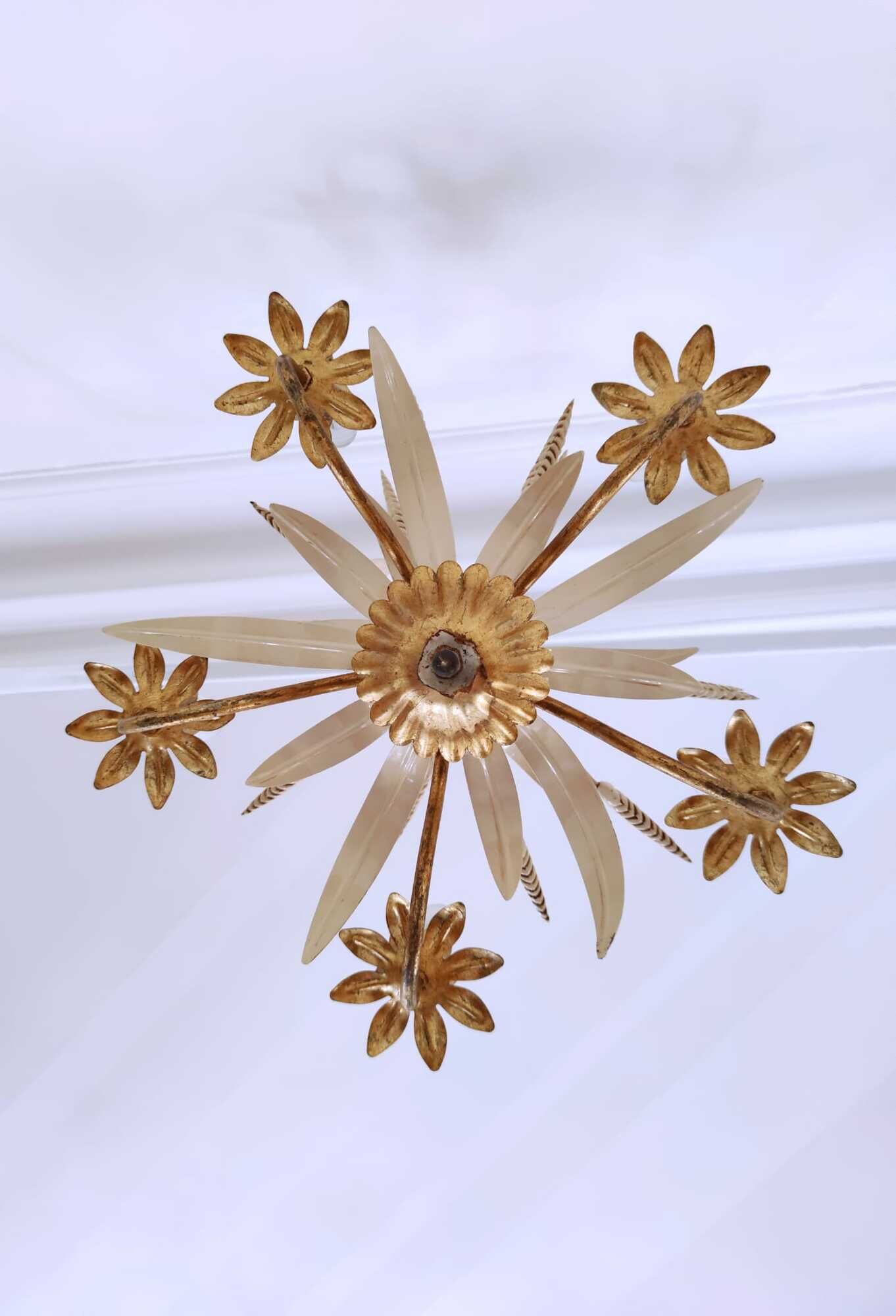 Vintage wrought iron chandelier decorated with golden and beige reeds