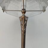 Art Nouveau style lamp, in bronze and frosted glass.