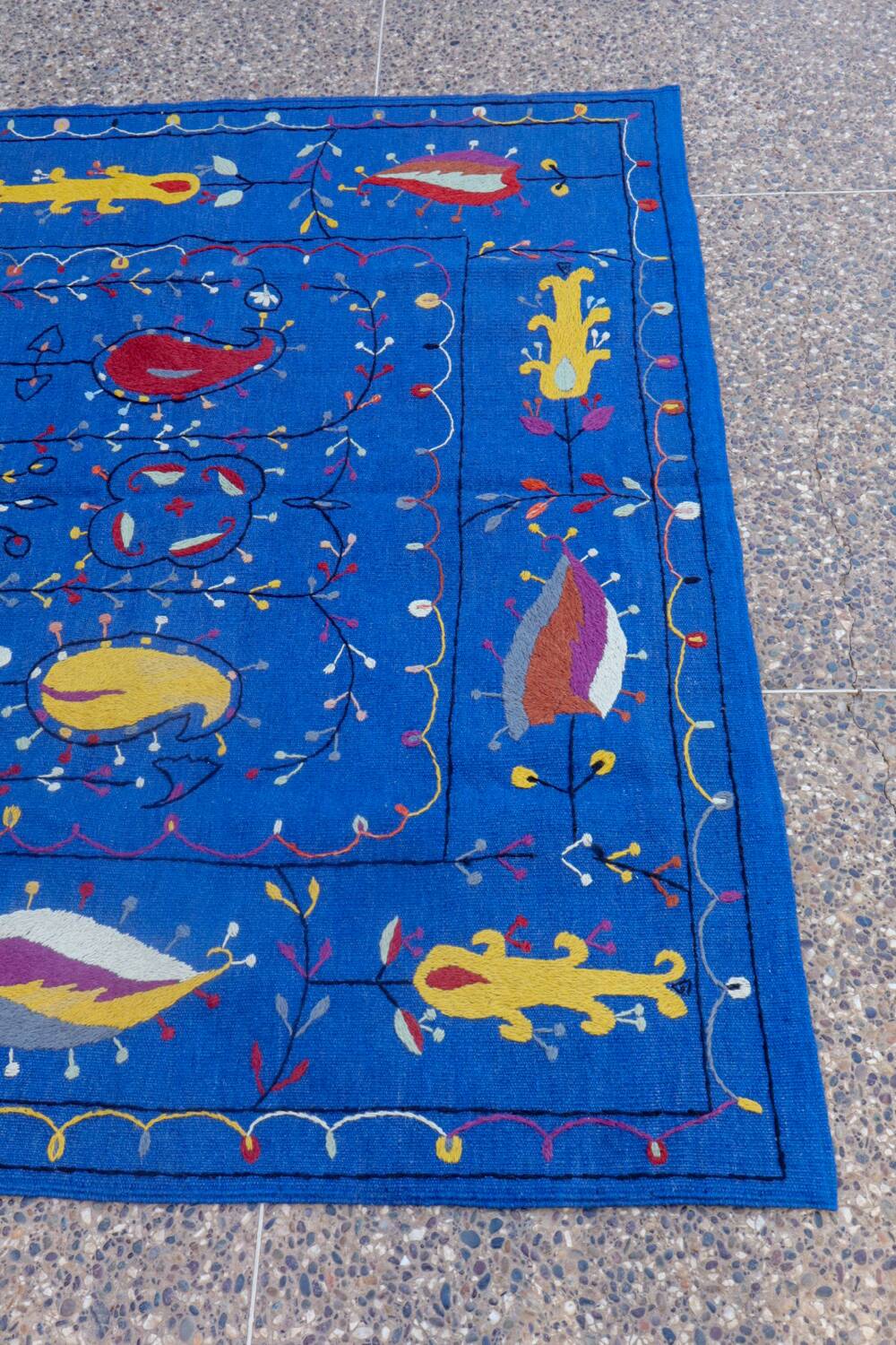 Midnight blue suzani kilim rug with embroidered patterns