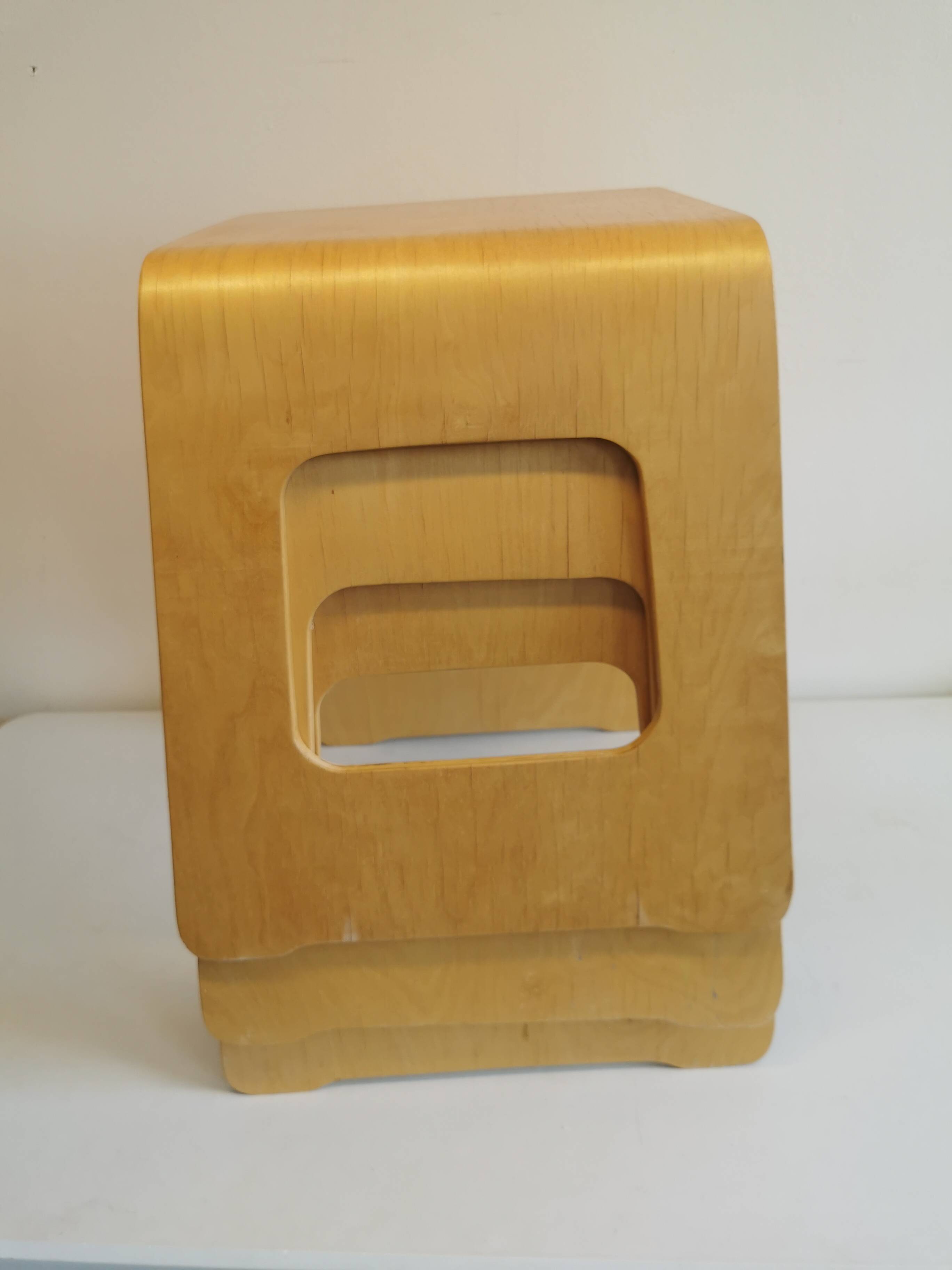 Design stool/side table made of curved plywood.